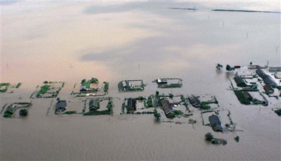 Floodwaters inundate houses and farmland in the North Korean city of Sinuiju. About a foot of rain Saturday sent the Yalu, or Amnok as its known in Korean, river over its banks.